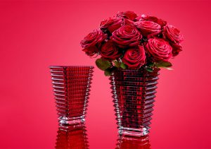 red glass vase with roses