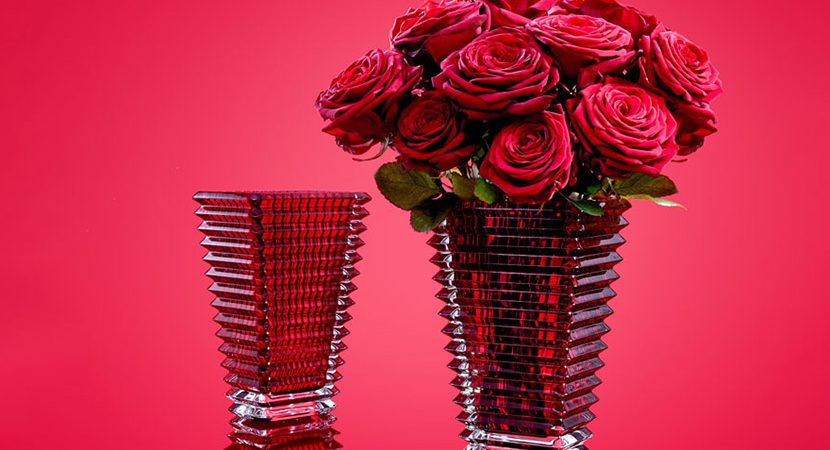 red glass vase with roses